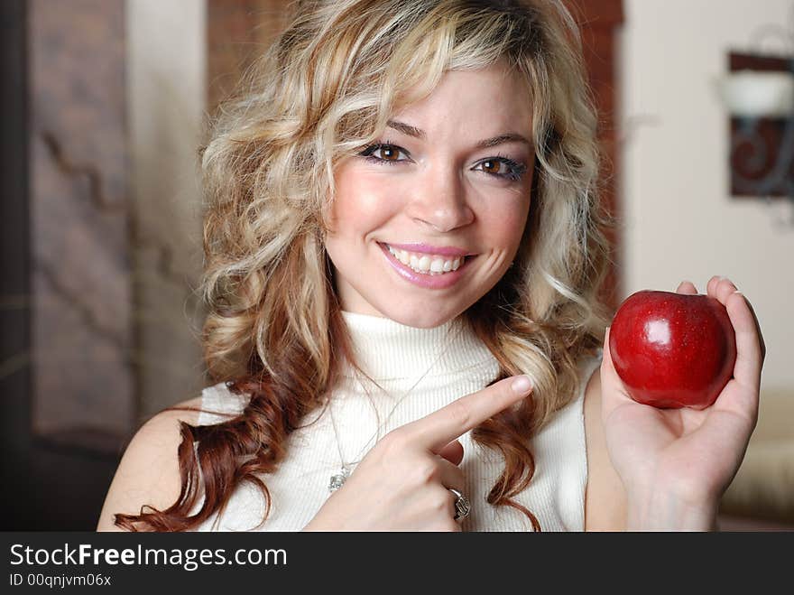 Beautiful woman is holding a fruit in her hands. Beautiful woman is holding a fruit in her hands