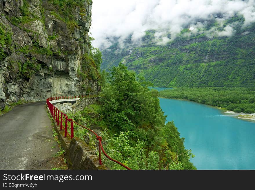 Mountain road and green lake