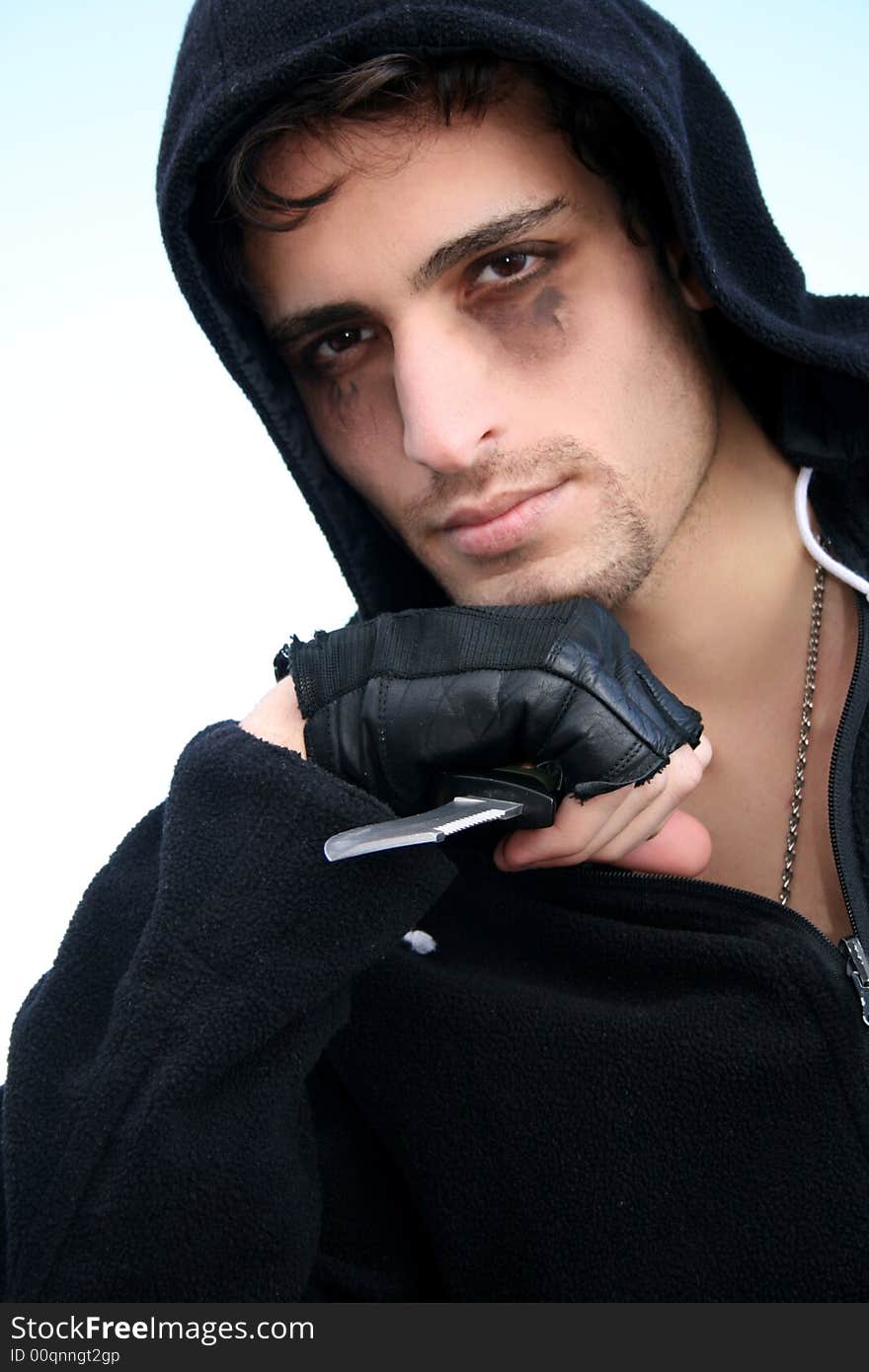 A dangerous attractive young man holding a knife