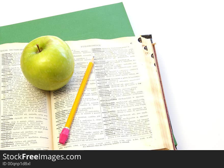 School supplies and studying concept with dictionary, notebook, pencil, and folders