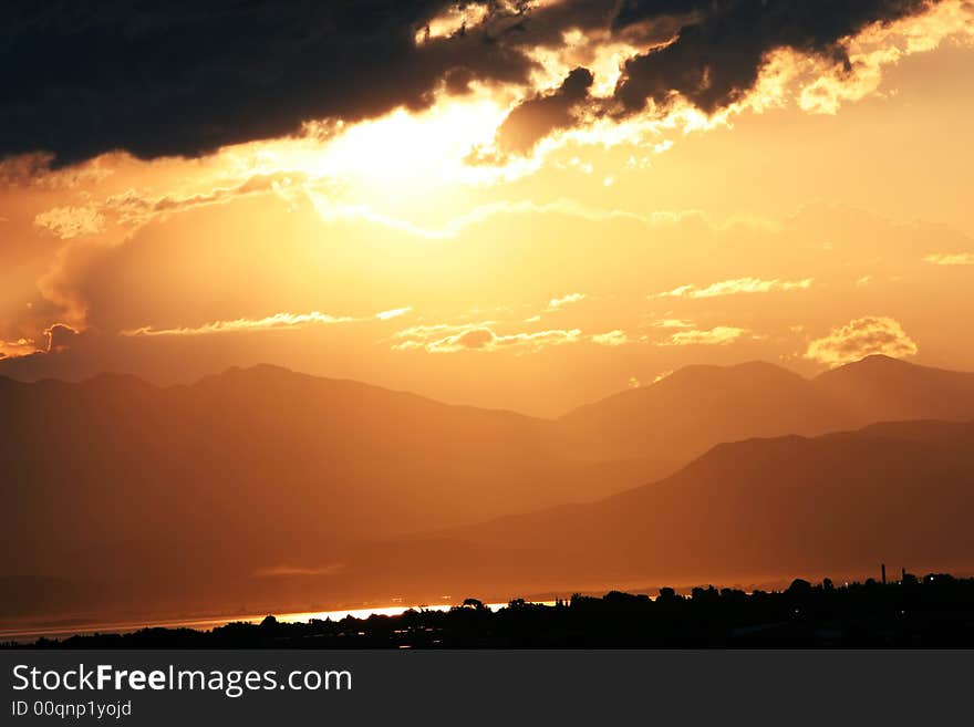 Sun setting over valley casts a copper cast. Sun setting over valley casts a copper cast