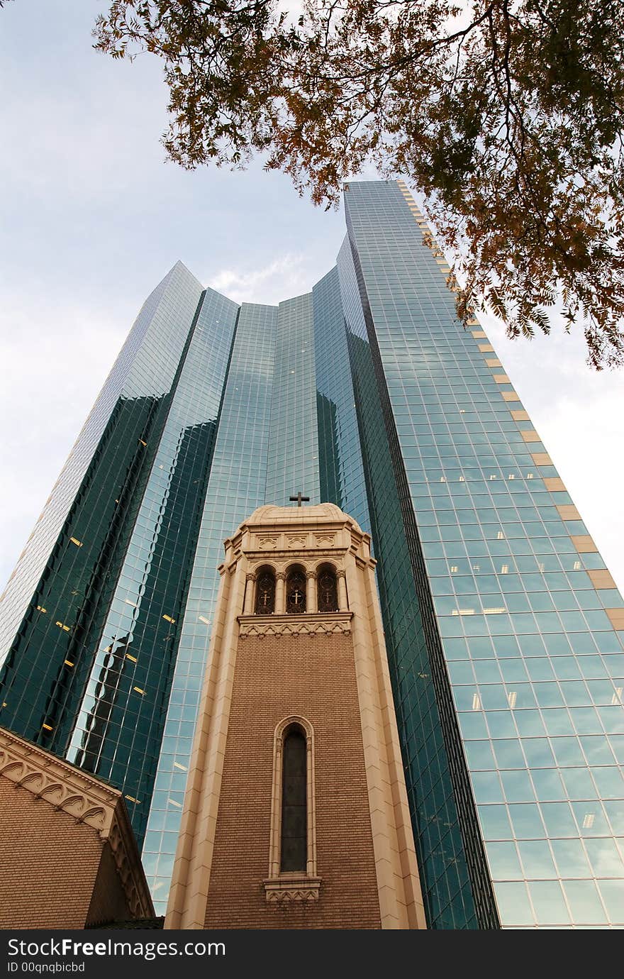 A church in downtown Denver surrounded by a sky scraper. A church in downtown Denver surrounded by a sky scraper