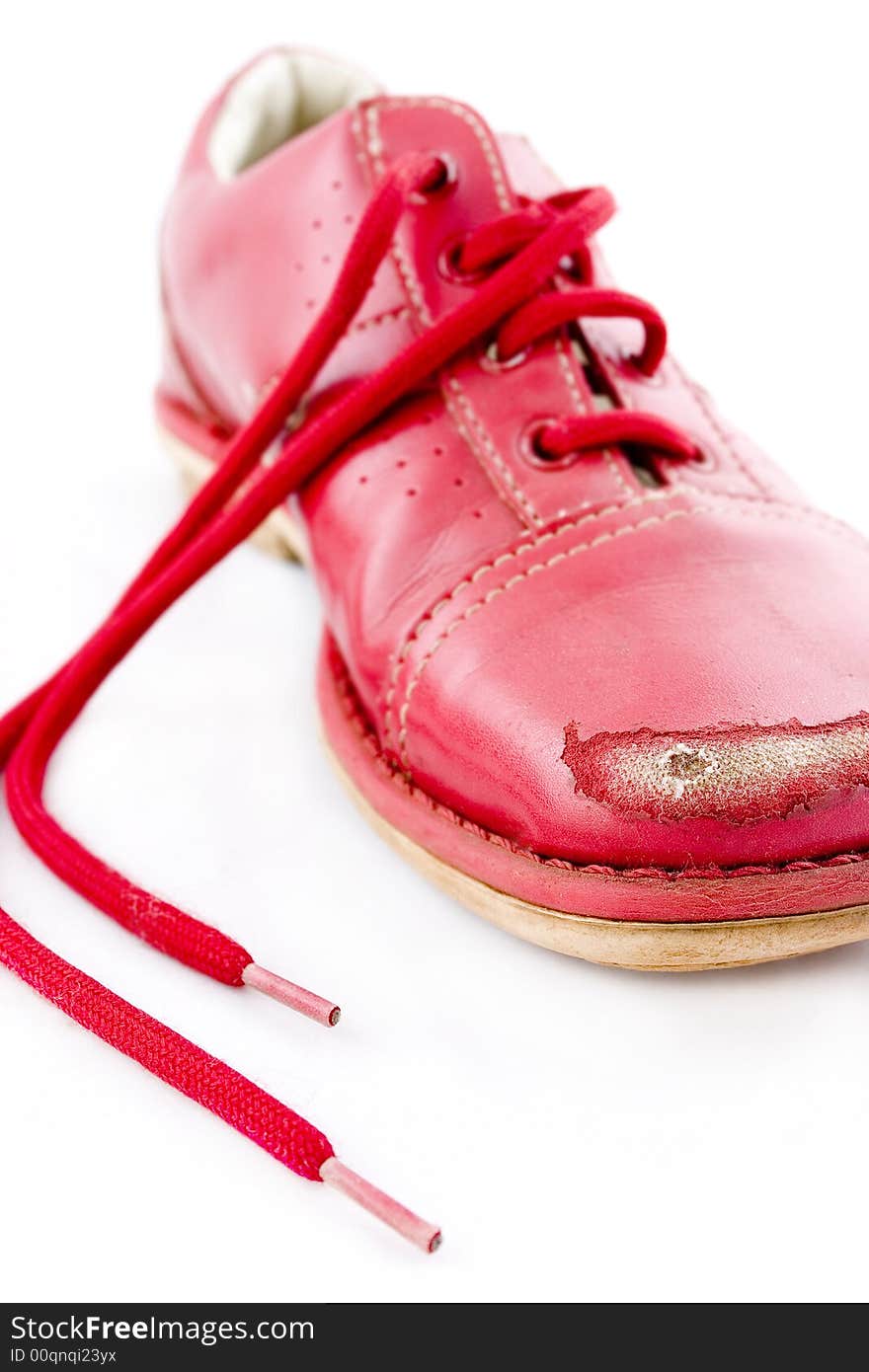 Damaged red shoes caused by kicking stones. Damaged red shoes caused by kicking stones