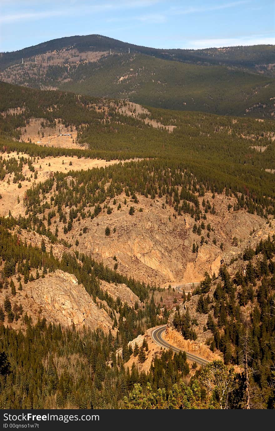 The Colorado Mountains at Estes Park showing the trees below and winding road. The Colorado Mountains at Estes Park showing the trees below and winding road.