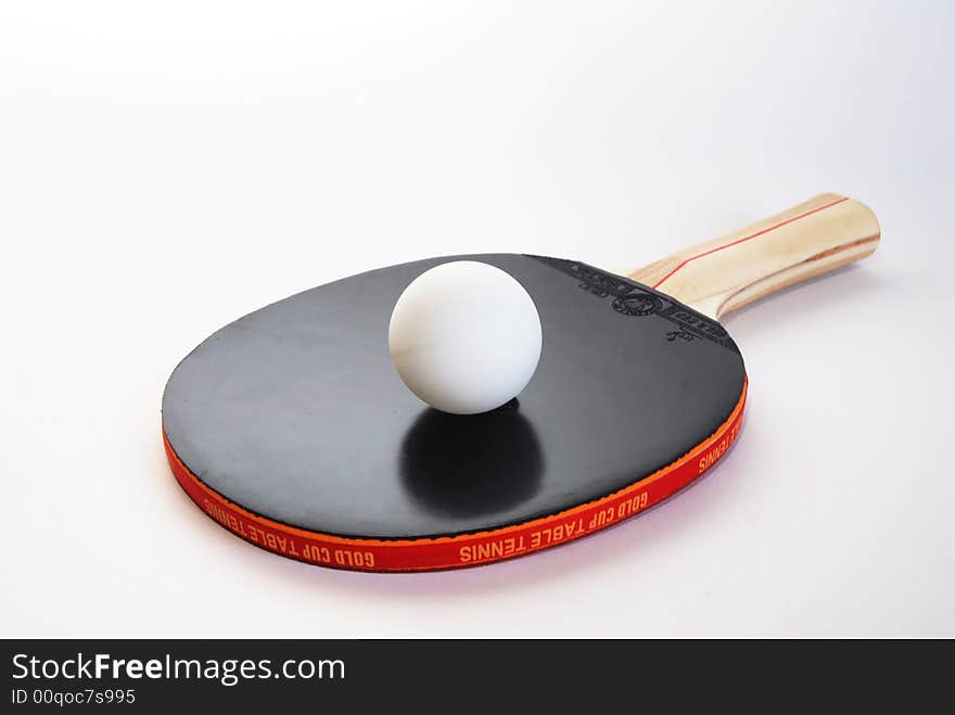 Black ping-pong paddle with the ball isolated on white