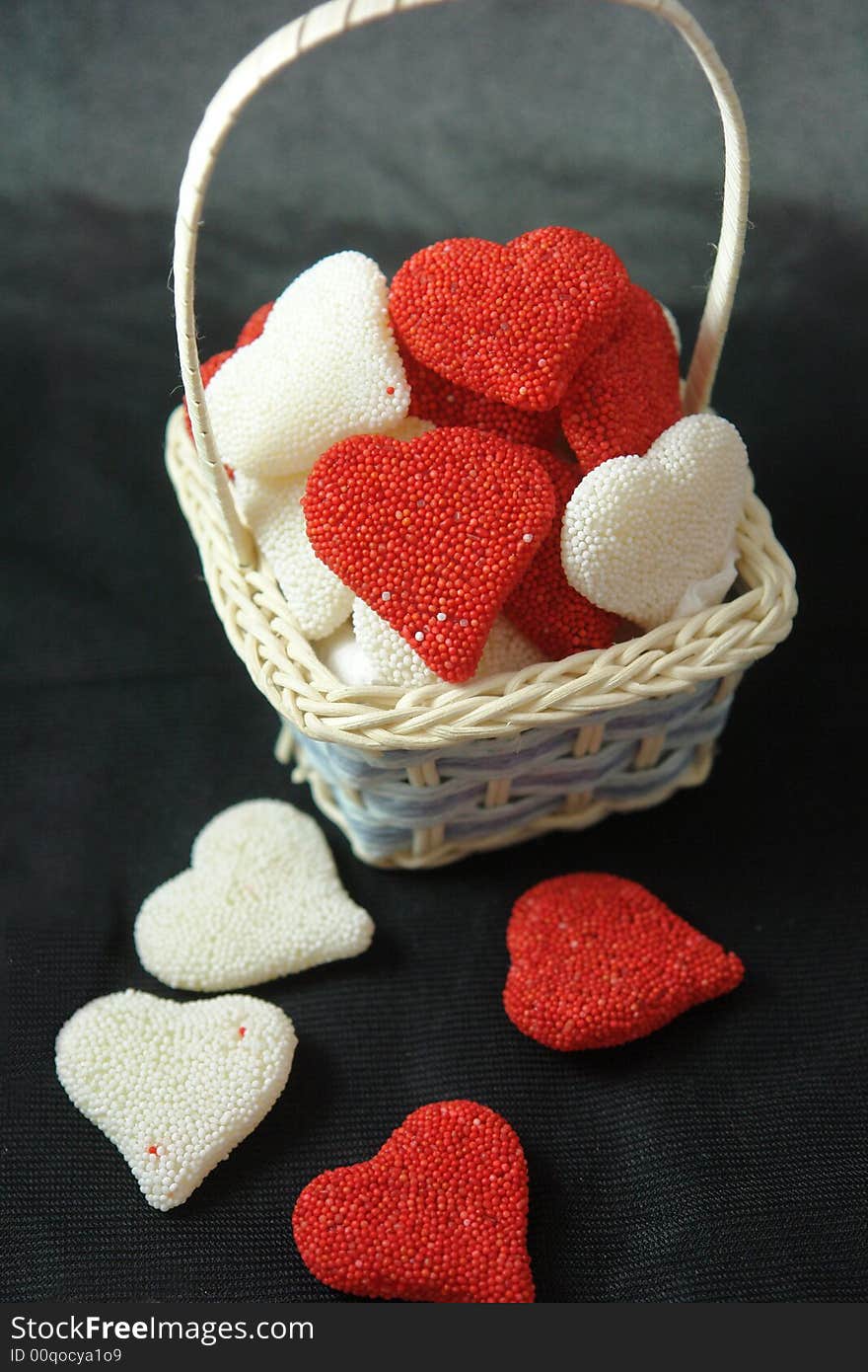 A picture of a basket of valentine red and white hearts. A picture of a basket of valentine red and white hearts