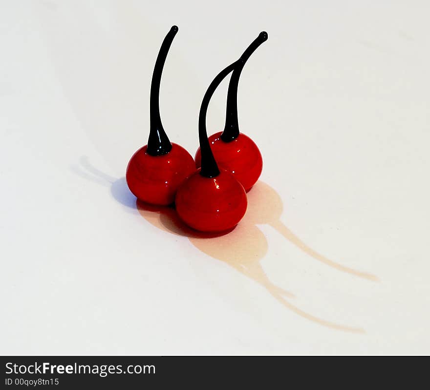 Three cherrys made from glass  with shadow