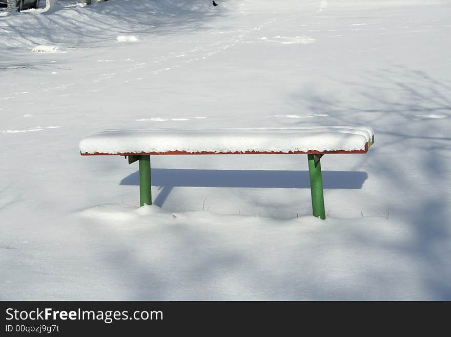 Wood bench in snow