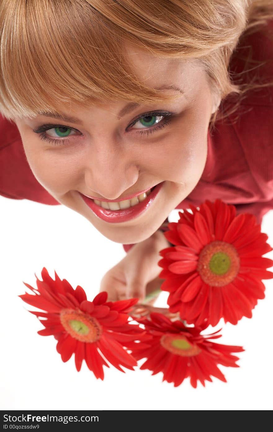 A smiling girl with flowers looking up. A smiling girl with flowers looking up