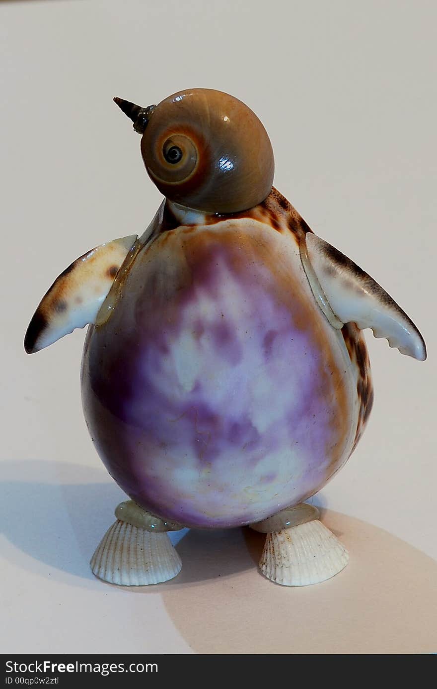 Penguin made from shell with shadow