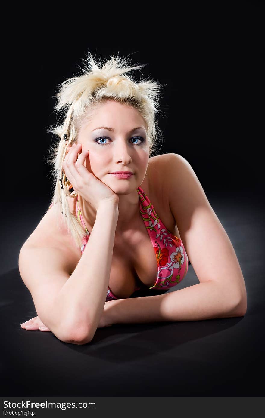 Caucasian young woman in bikini leaning her head on her hand look at camera. Caucasian young woman in bikini leaning her head on her hand look at camera