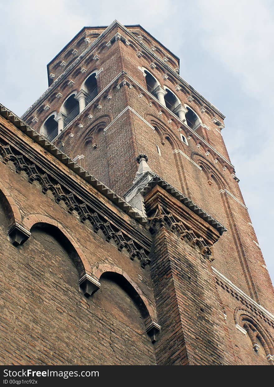 Church tower in Venice, Italy, against sky; looking up view