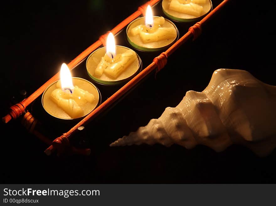 Japan candle with shell on the black background. Japan candle with shell on the black background