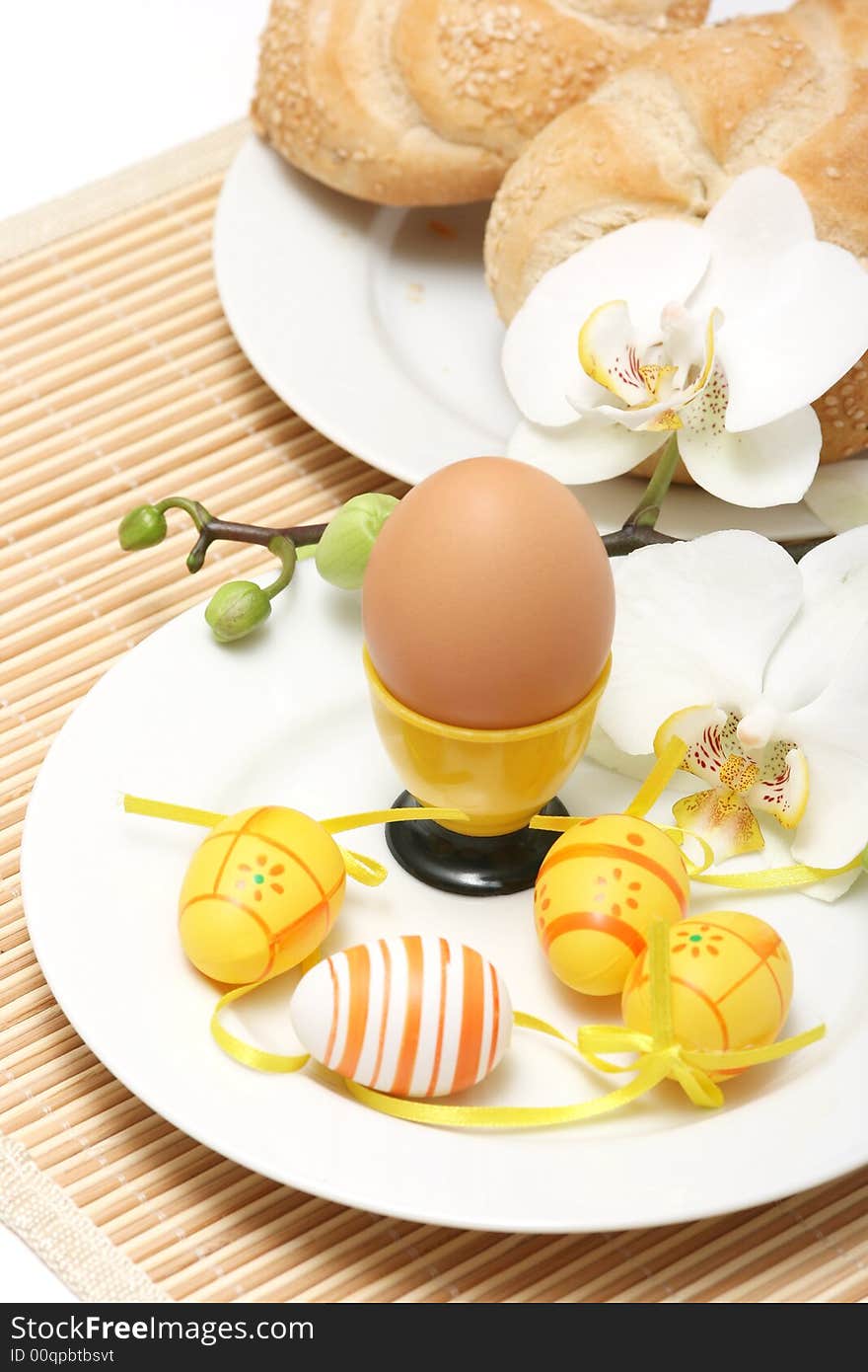 Nature egg with easter colored eggs and orchid on a table. Nature egg with easter colored eggs and orchid on a table.