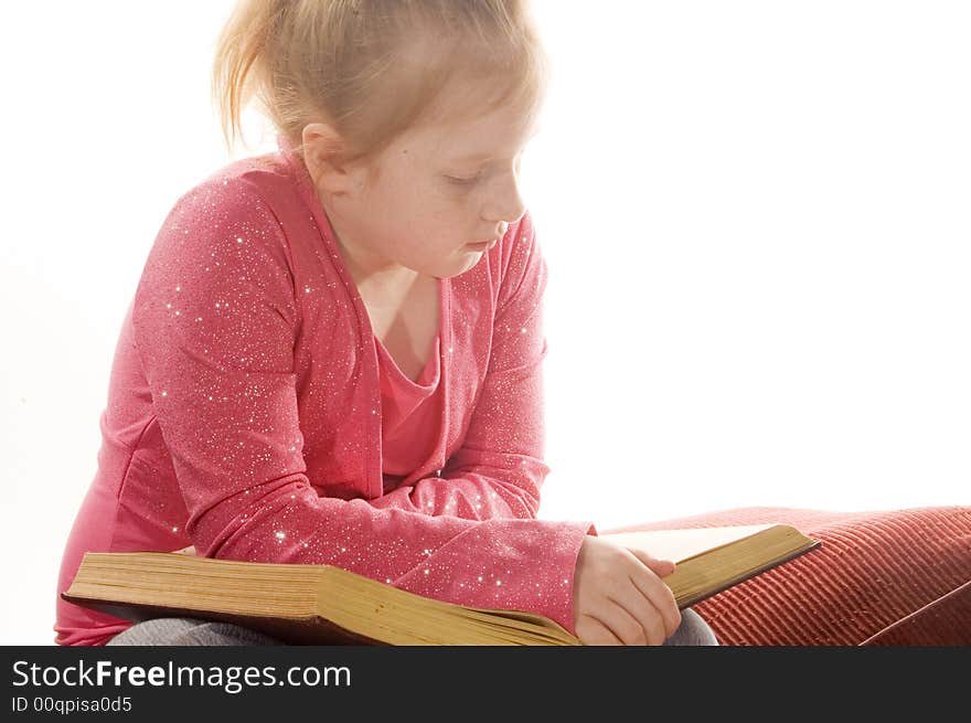 Little girl is reading a book