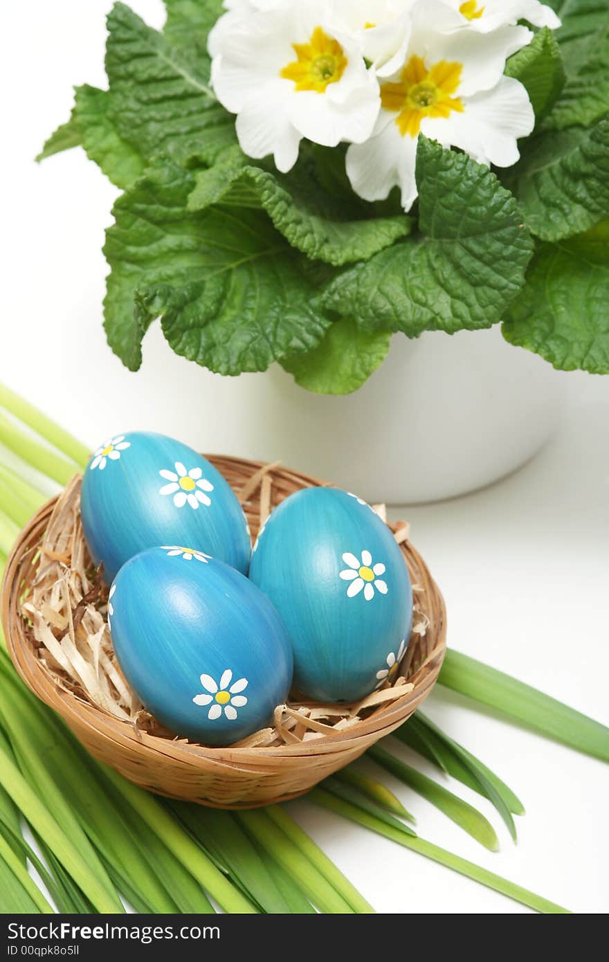 Blue easter eggs in basket on grass with flower. Blue easter eggs in basket on grass with flower.