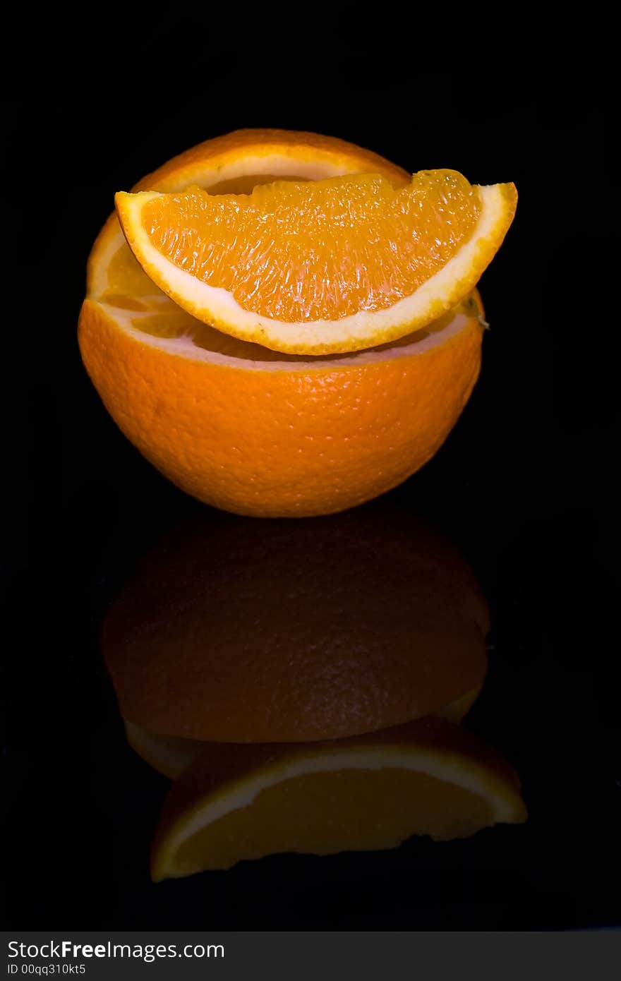 Orange on a black background with a slice