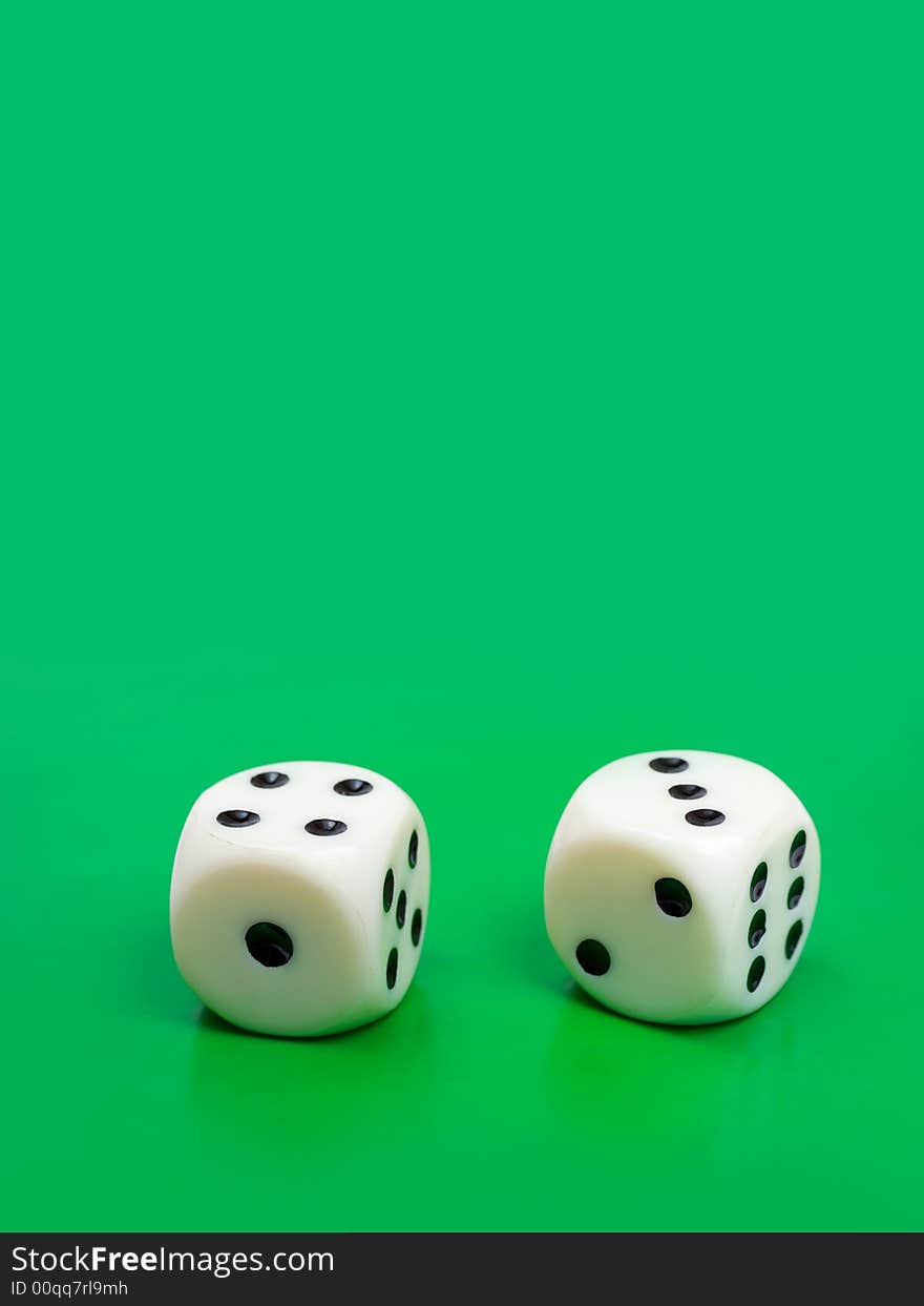 Two gambling dices on green background