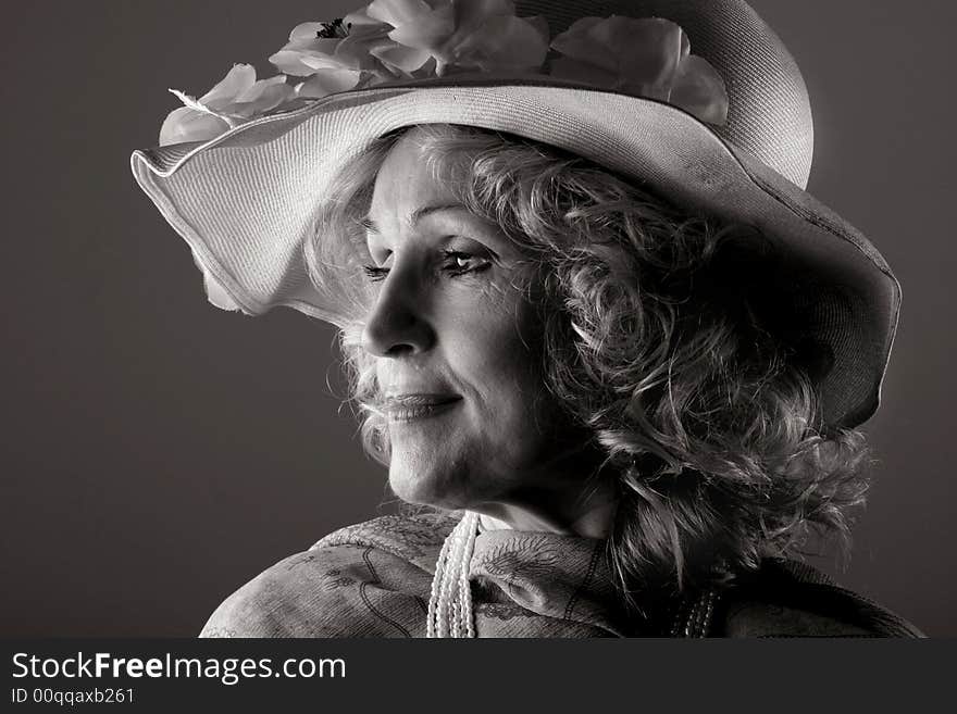 A senior woman with a elegant hat. A senior woman with a elegant hat