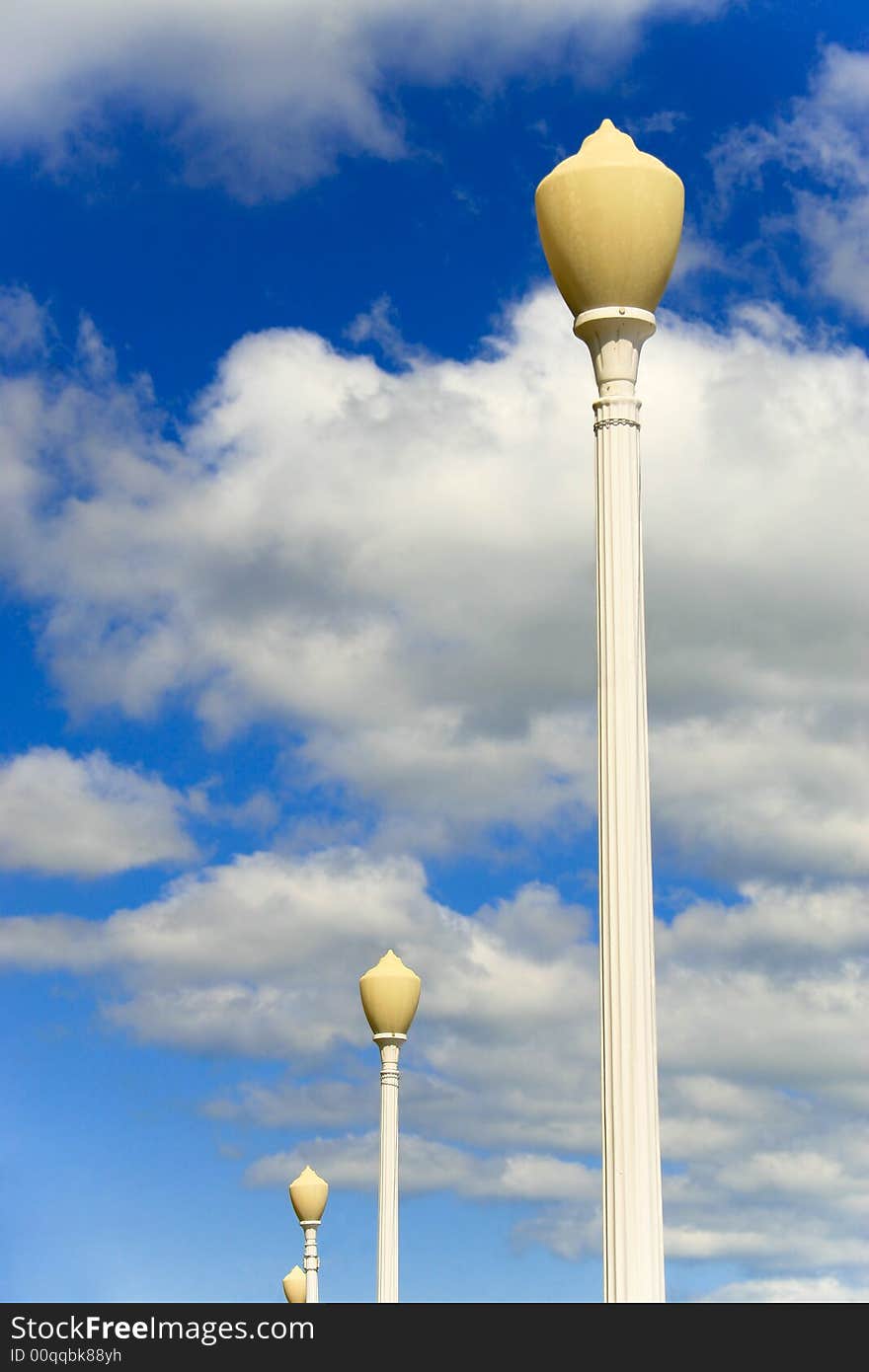 Lamp posts with cloudy sky