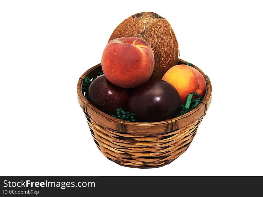 A fruit basket containing plums, peaches and a coconut. A fruit basket containing plums, peaches and a coconut.