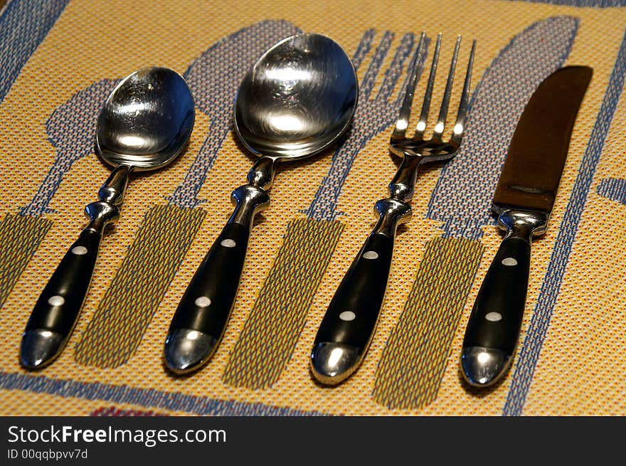 Swedish table linen serves as a backdrop for a cutlery grouping. Swedish table linen serves as a backdrop for a cutlery grouping.