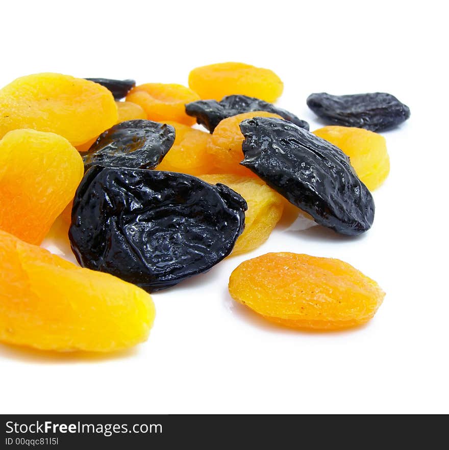 Dried apricot and black plum fruits isolated over white background