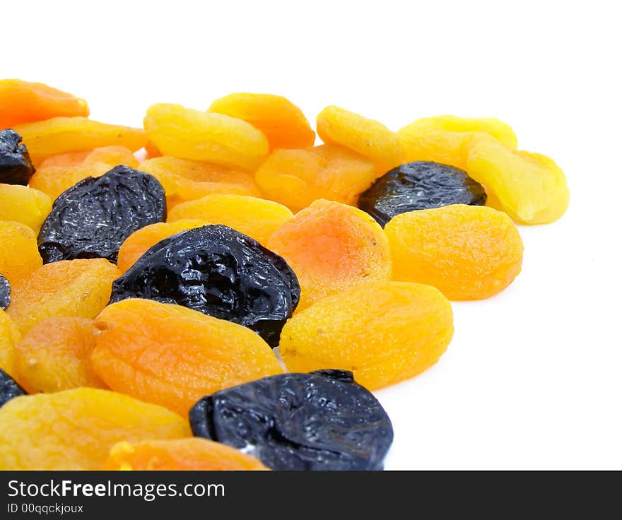 Dried apricot and black plum fruits isolated over white background