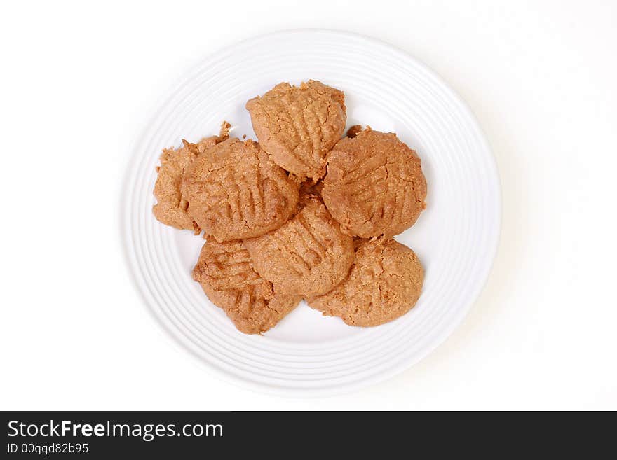 Peanut butter cookies on white plate on white background