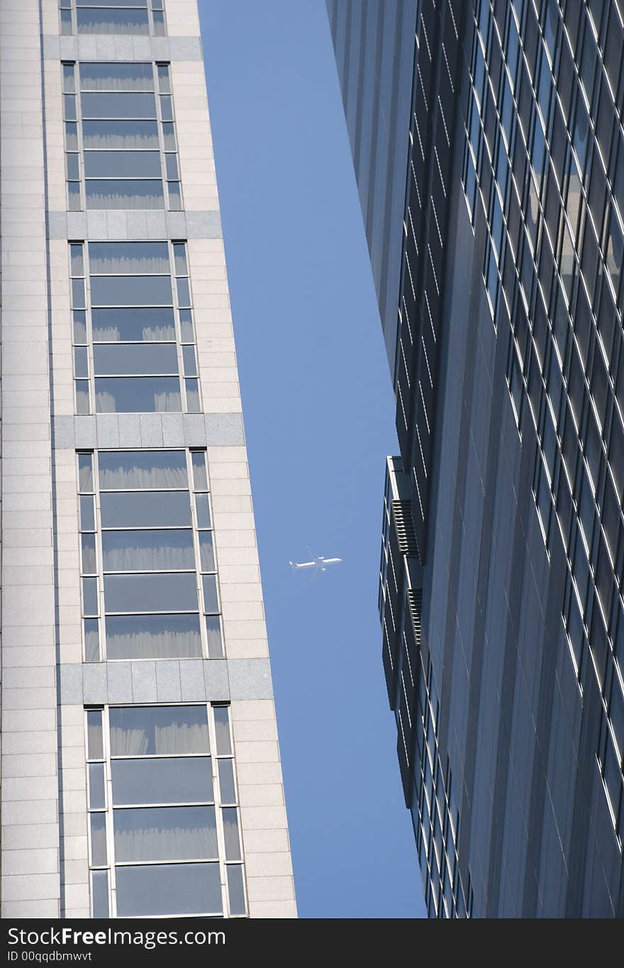 A plane is framed passing between the space in two skyscrapers in Hong Kong City. A plane is framed passing between the space in two skyscrapers in Hong Kong City