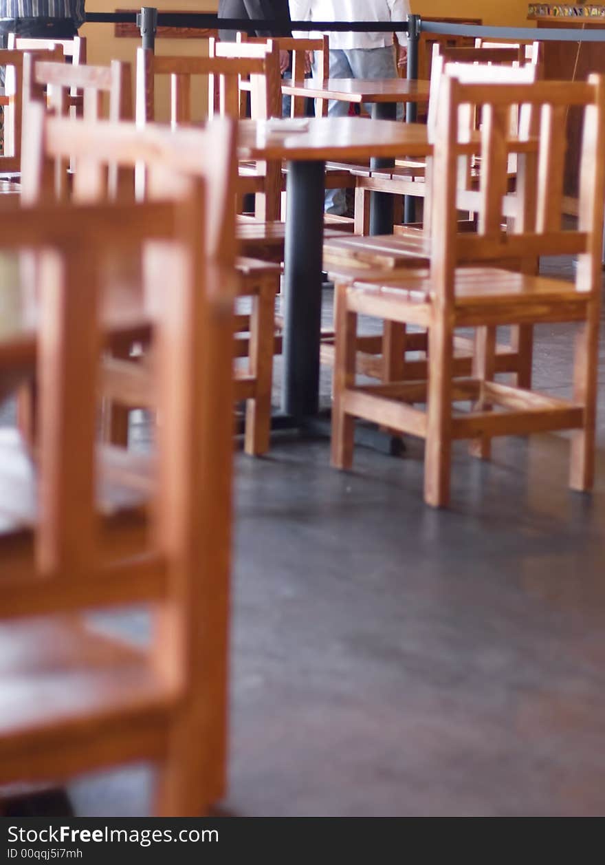 Chairs, tables, and people waiting in line inside restaurant. Chairs, tables, and people waiting in line inside restaurant