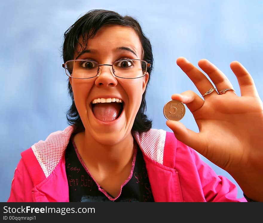 The joyful girl with a coin in a hand . The fish eye.