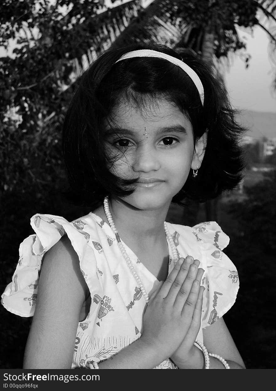 A small Hindu girl doing her morning prayer. A small Hindu girl doing her morning prayer.