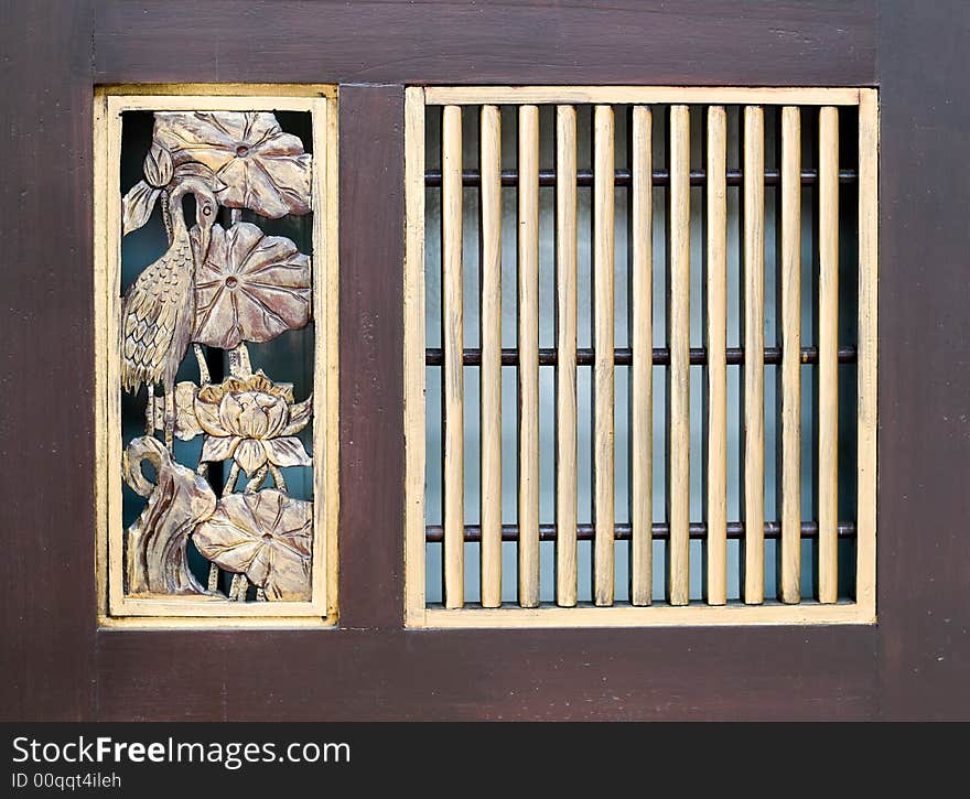 Details of carved decorations on wooden swing door of peranakan styled house. Details of carved decorations on wooden swing door of peranakan styled house