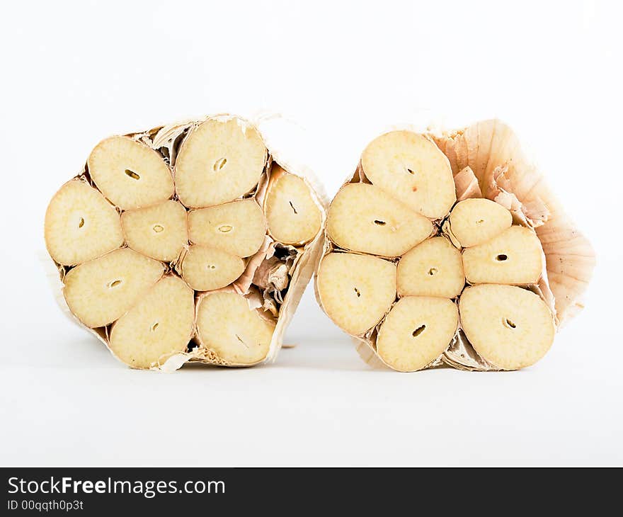 Cross section of a large garlic bulb revealing  the halved individual cloves. Cross section of a large garlic bulb revealing  the halved individual cloves