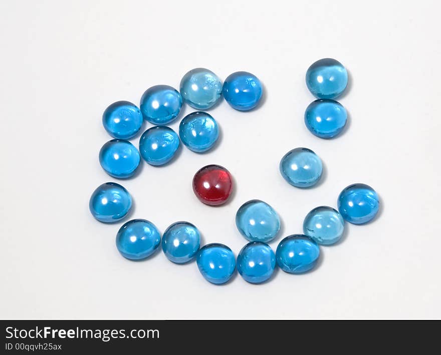 A red glass stone within blue ones for background decoration. A red glass stone within blue ones for background decoration