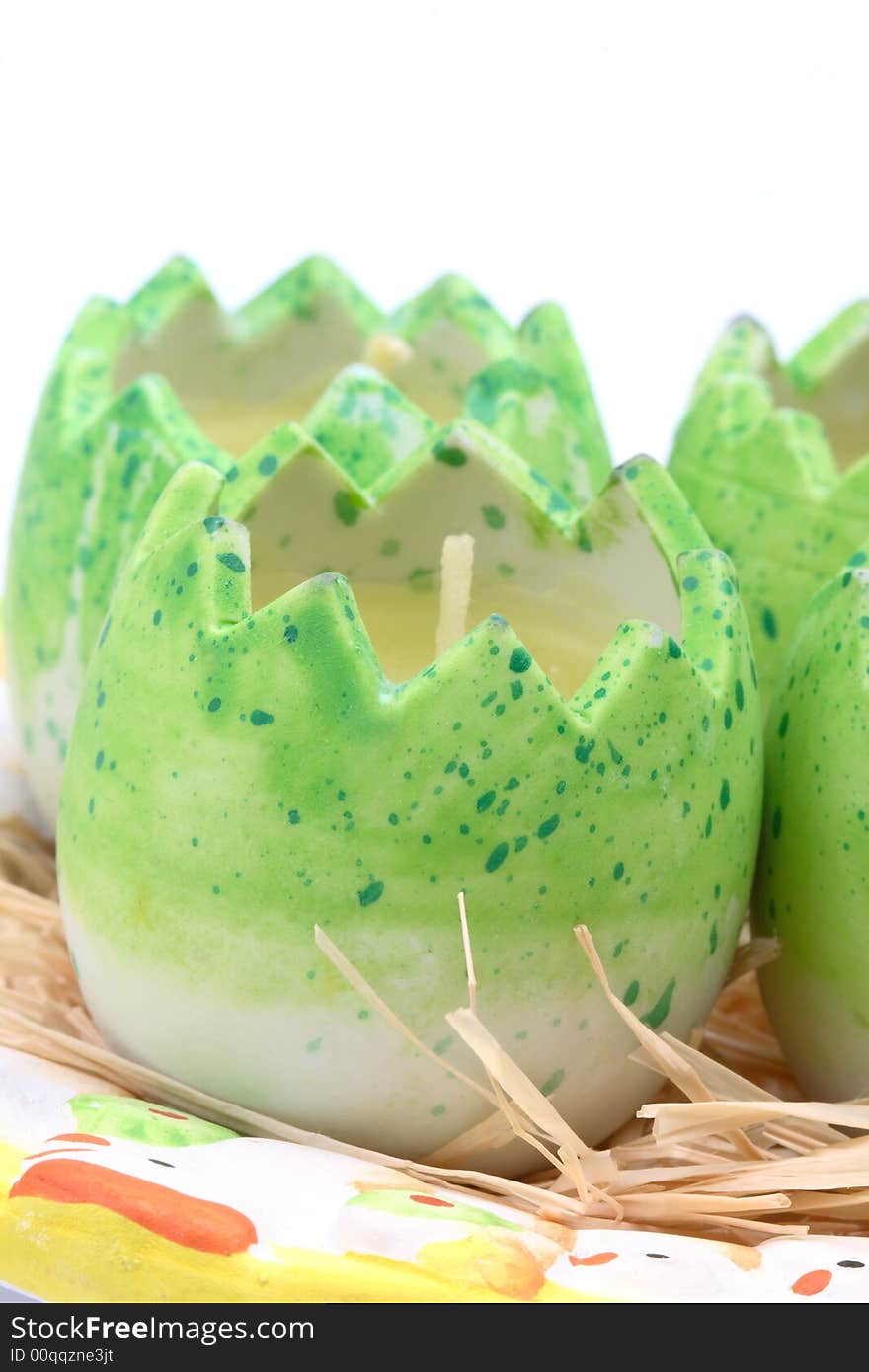 Easter candles- green eggs on a plate. Easter candles- green eggs on a plate