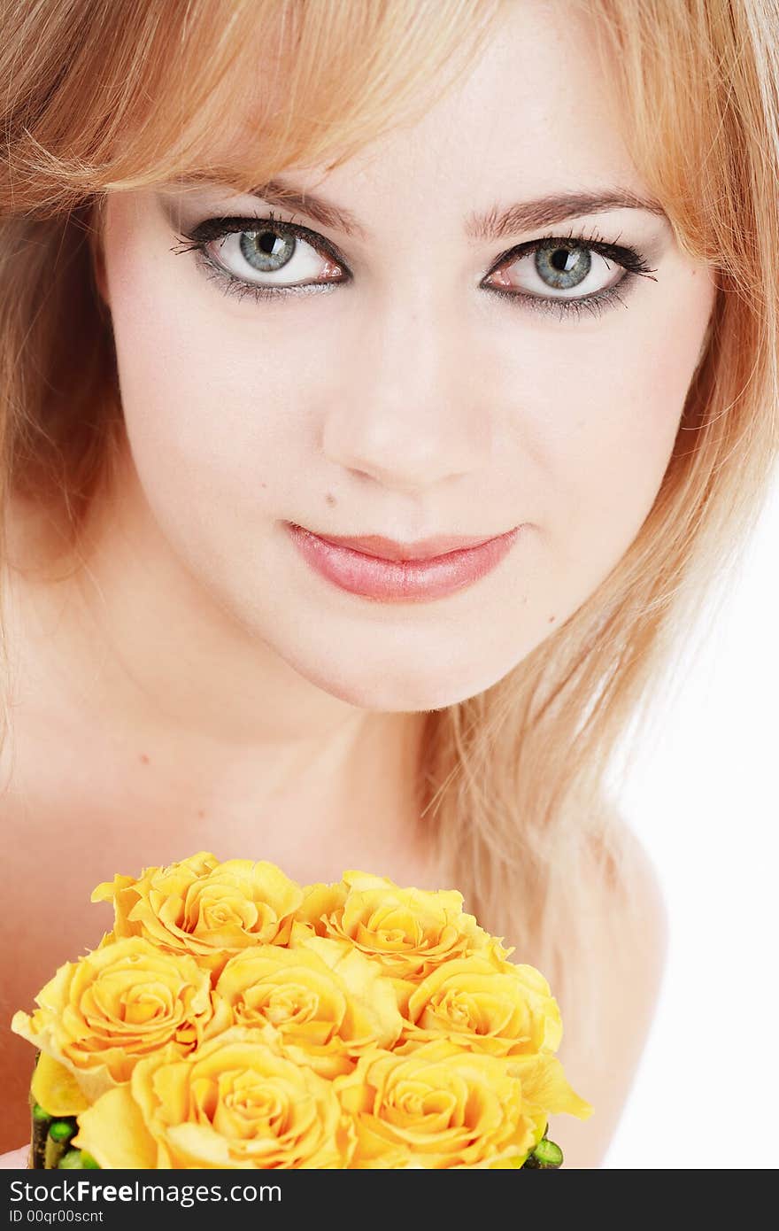 Close-up portrait pf pretty girl with huge grey eyes holding yellow roses in hands. Close-up portrait pf pretty girl with huge grey eyes holding yellow roses in hands