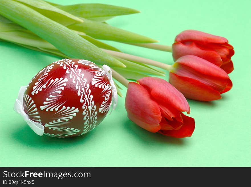 Painted Easter Egg and red tulips