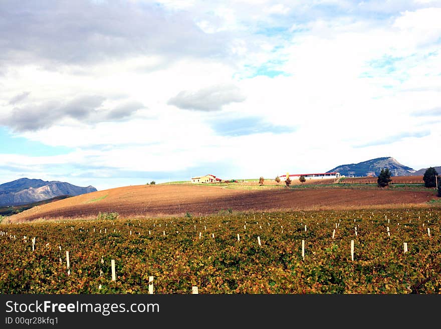 Cloudy autumnal sky and country. Beautiful autumn country landscape.  cultivated land, hills,  blue sky & clouds. Sicily, Italy. Cloudy autumnal sky and country. Beautiful autumn country landscape.  cultivated land, hills,  blue sky & clouds. Sicily, Italy