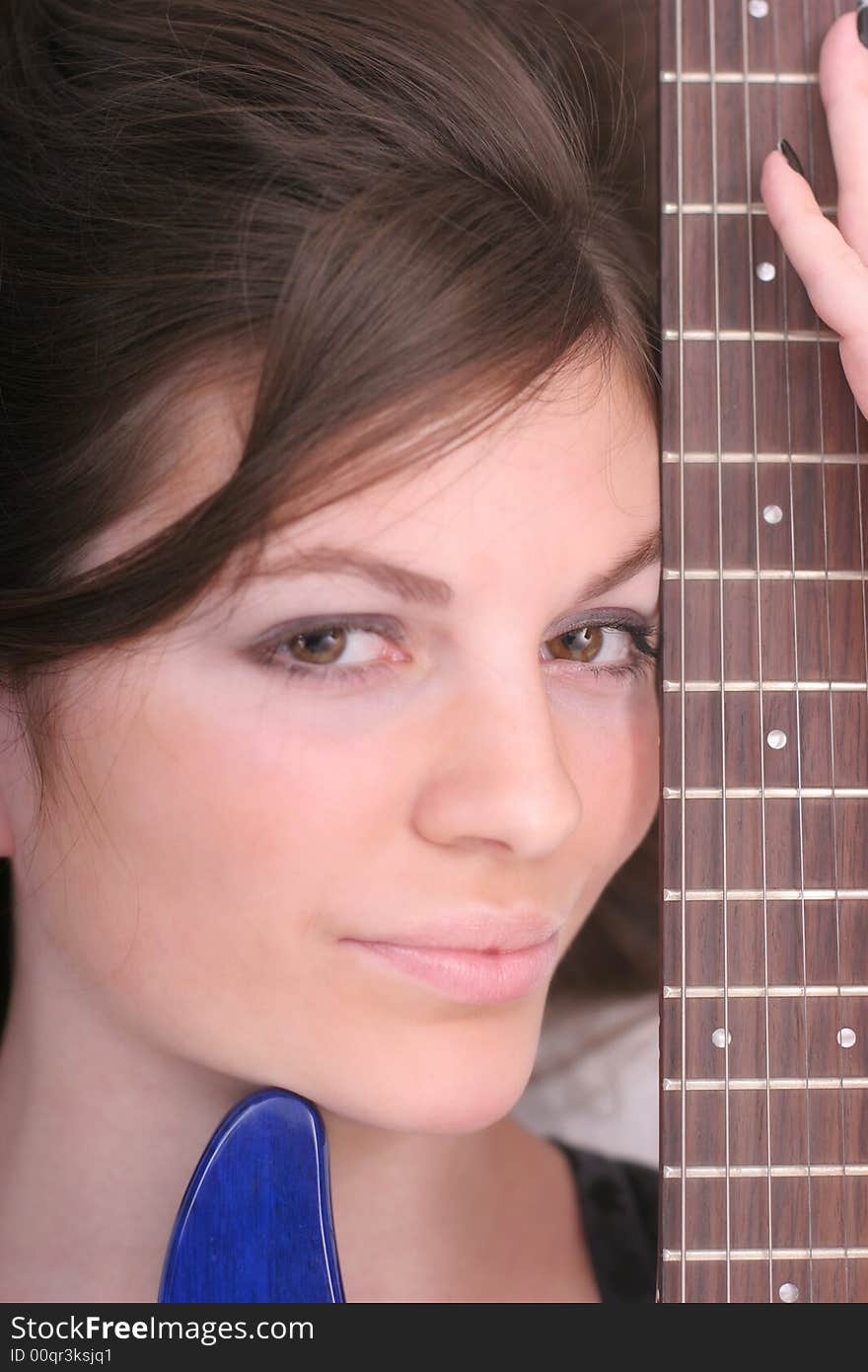 Portrait of a cute brunette with guitar. Portrait of a cute brunette with guitar