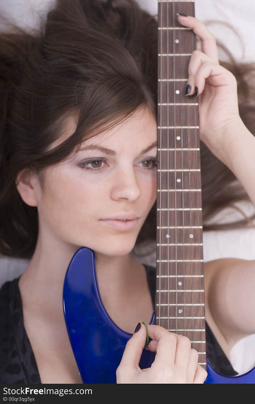 Portrait of a cute brunette with guitar. Portrait of a cute brunette with guitar