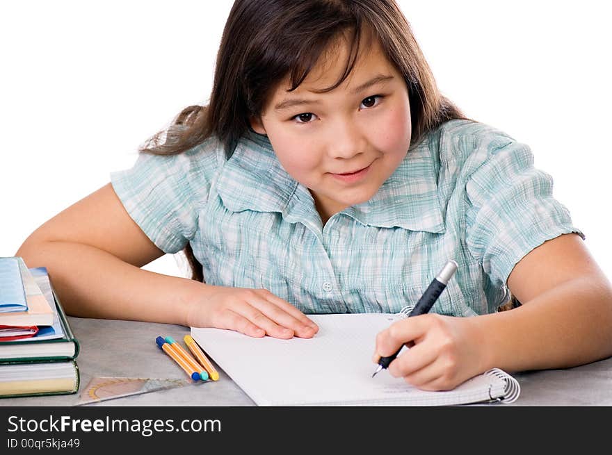 The girl does homework, isolated on a white background. The girl does homework, isolated on a white background.