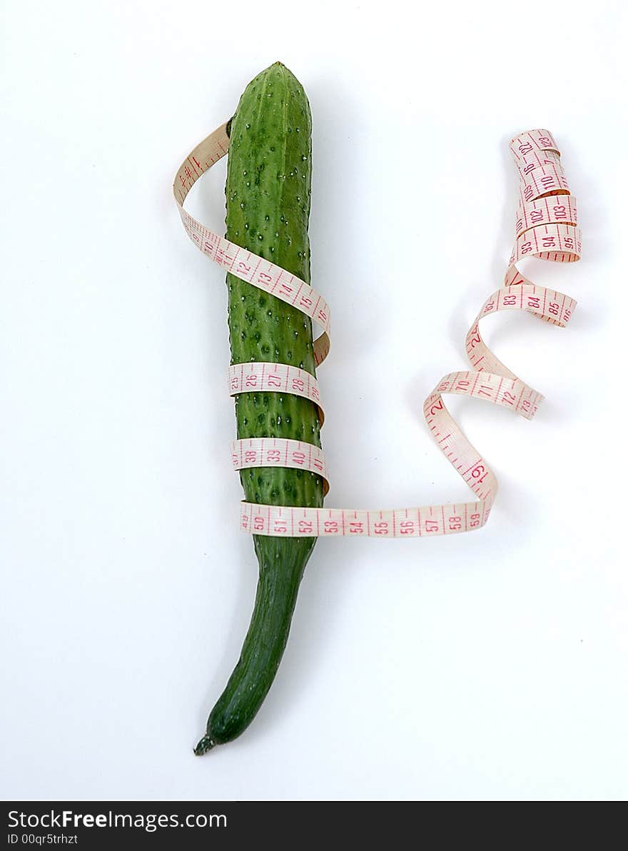 A  Cucumber   and a  tape on the white background. A  Cucumber   and a  tape on the white background