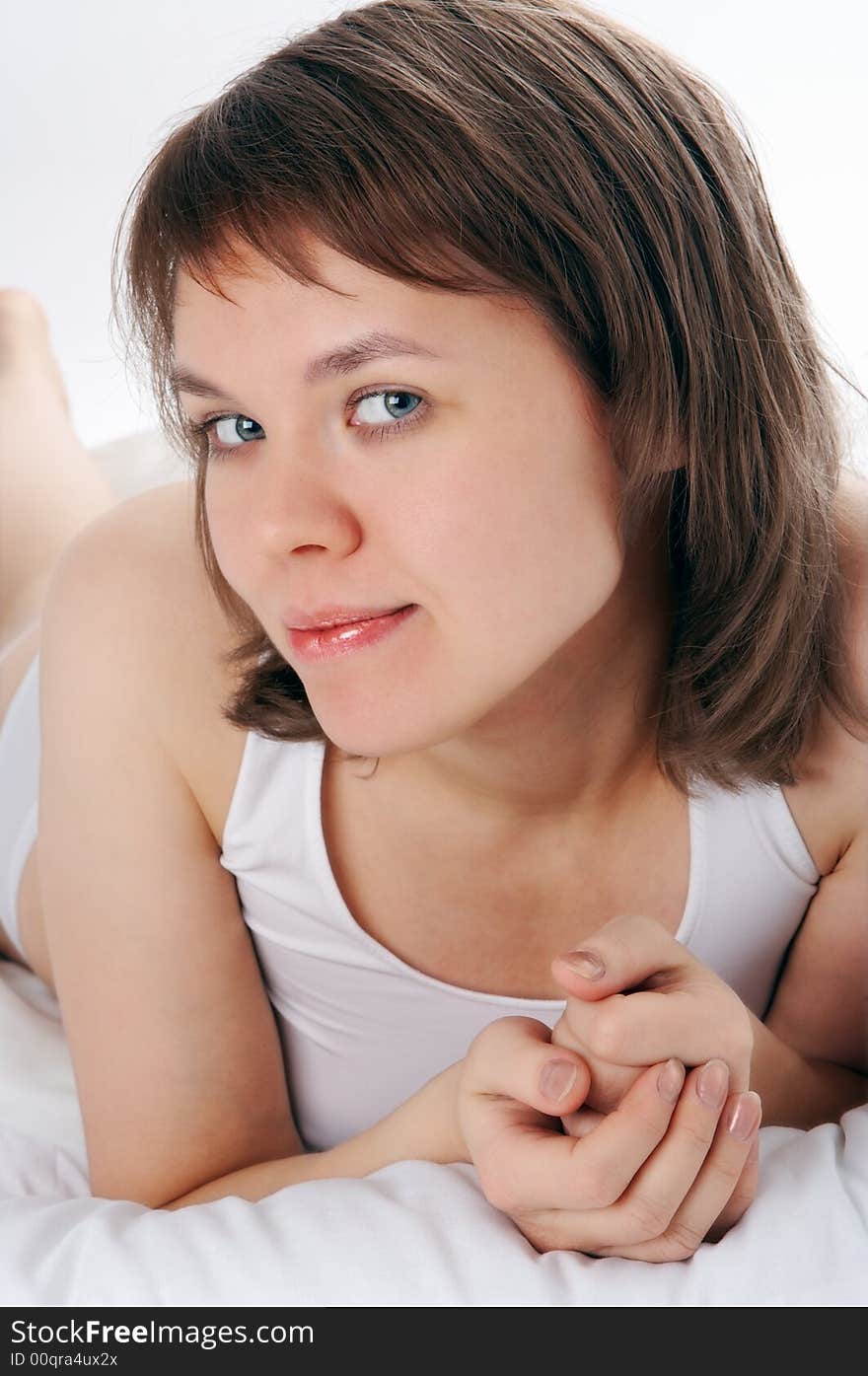 Young woman lie in bed