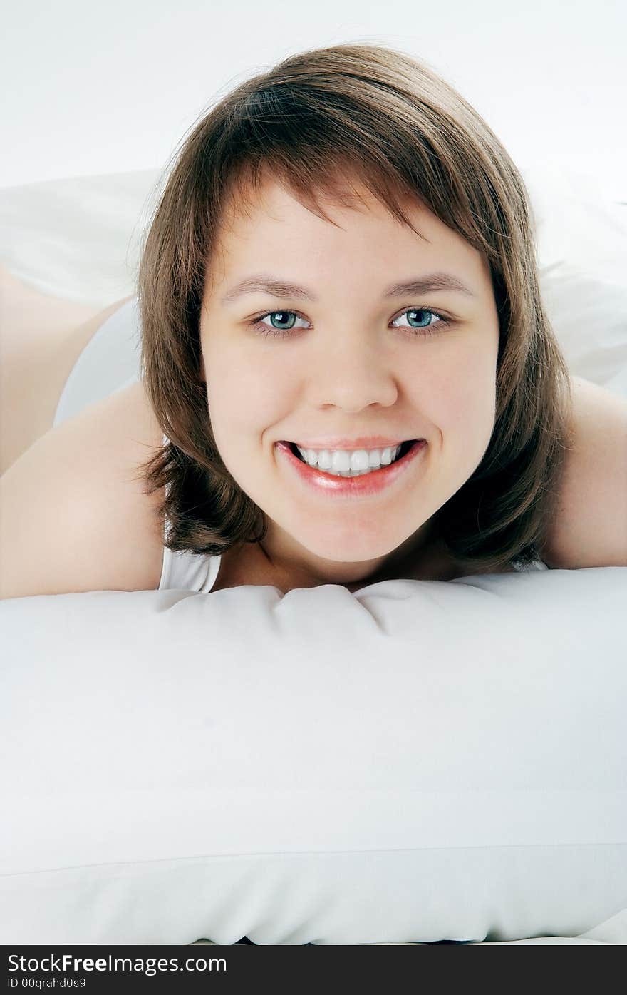 Young smiling woman lie in bed. Young smiling woman lie in bed