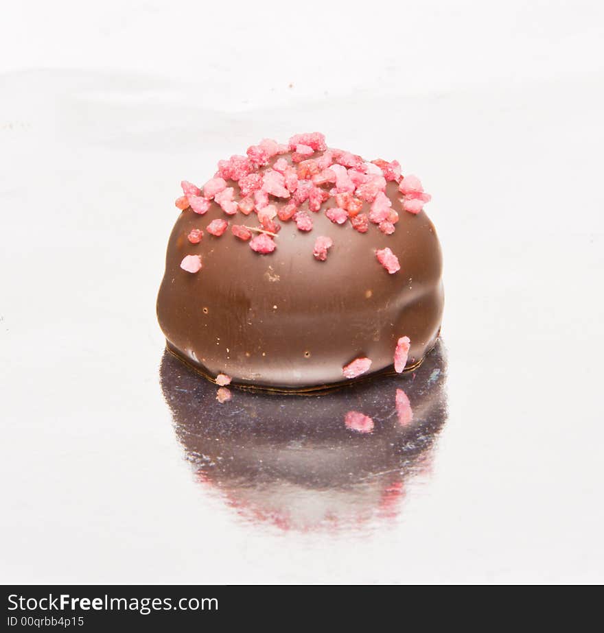 Famous Belgian chocolate candies. Close-up. Reflection in foil.