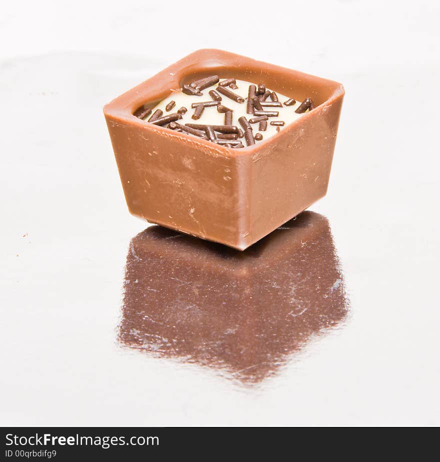 Famous Belgian chocolate candies.  Close-up. Reflection in foil.