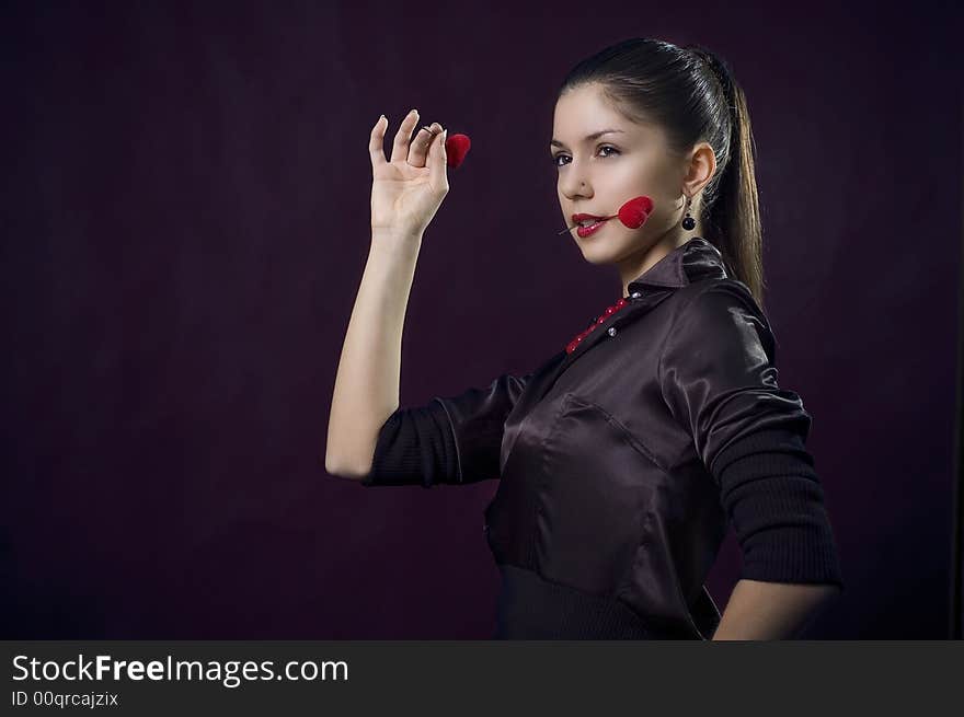 Beautiful female playing darts with hearts. Beautiful female playing darts with hearts