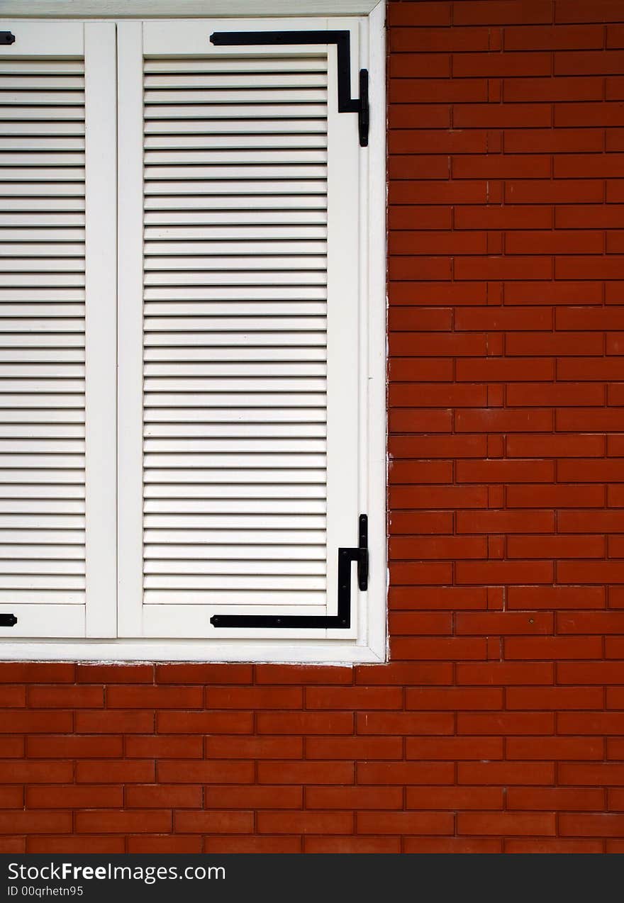 Chromatic composition based on the contrast of a closed white window on red bricks. Chromatic composition based on the contrast of a closed white window on red bricks